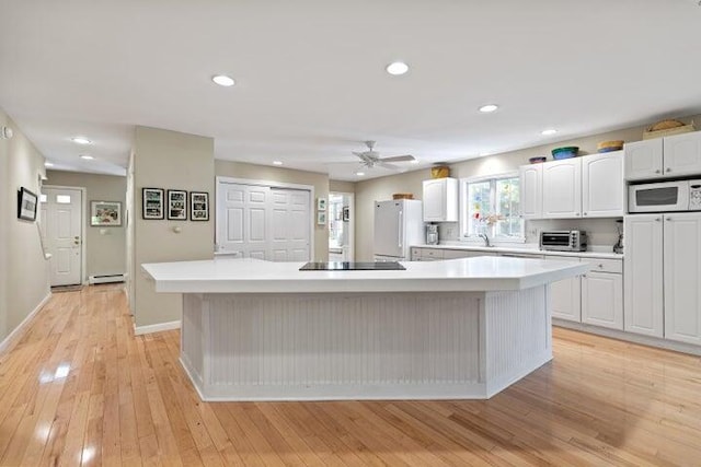 21 Oakmont Dr Unit 21, Old Orchard Beach, ME 04064 - kitchen featuring a center island, white cabinetry, and white appliances