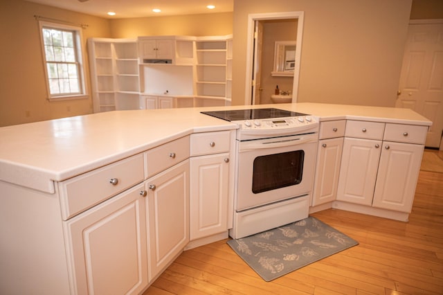 21 Oakmont Dr Unit 21, Old Orchard Beach, ME 04064 - kitchen featuring white cabinets, electric range, recessed lighting, light wood-style floors, and light countertops