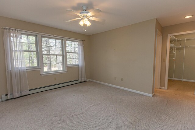 21 Oakmont Dr Unit 21, Old Orchard Beach, ME 04064 - unfurnished room featuring a baseboard heating unit, baseboards, light colored carpet, and ceiling fan