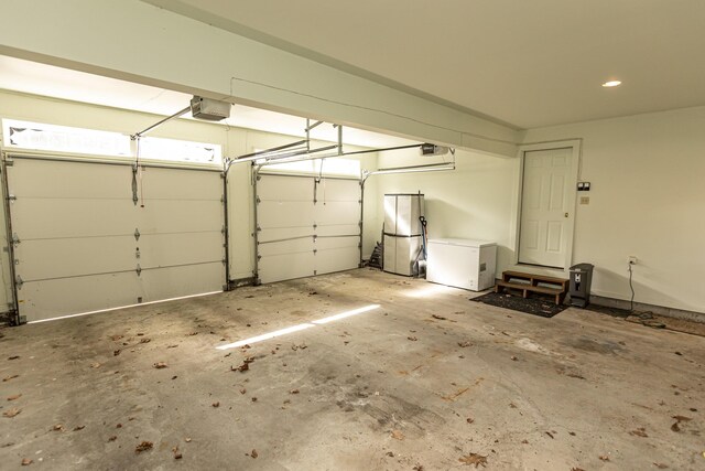 21 Oakmont Dr Unit 21, Old Orchard Beach, ME 04064 - garage featuring a garage door opener and fridge