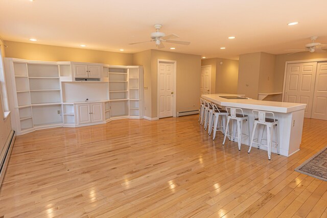 21 Oakmont Dr Unit 21, Old Orchard Beach, ME 04064 - kitchen featuring a baseboard radiator, light wood-type flooring, a ceiling fan, and recessed lighting