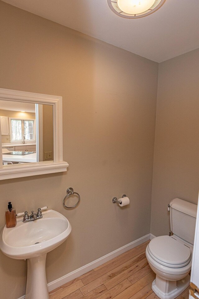 21 Oakmont Dr Unit 21, Old Orchard Beach, ME 04064 - half bathroom with wood finished floors, toilet, and baseboards