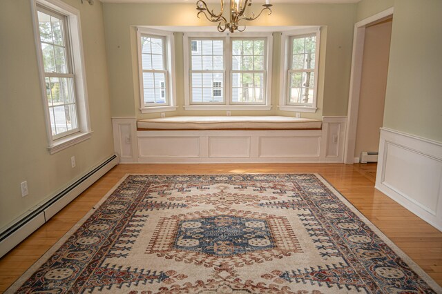 21 Oakmont Dr Unit 21, Old Orchard Beach, ME 04064 - unfurnished dining area with a chandelier, light wood-type flooring, wainscoting, a baseboard radiator, and baseboard heating