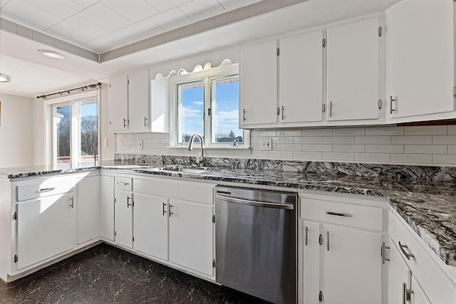 kitchen featuring decorative backsplash, a healthy amount of sunlight, dishwasher, and a sink