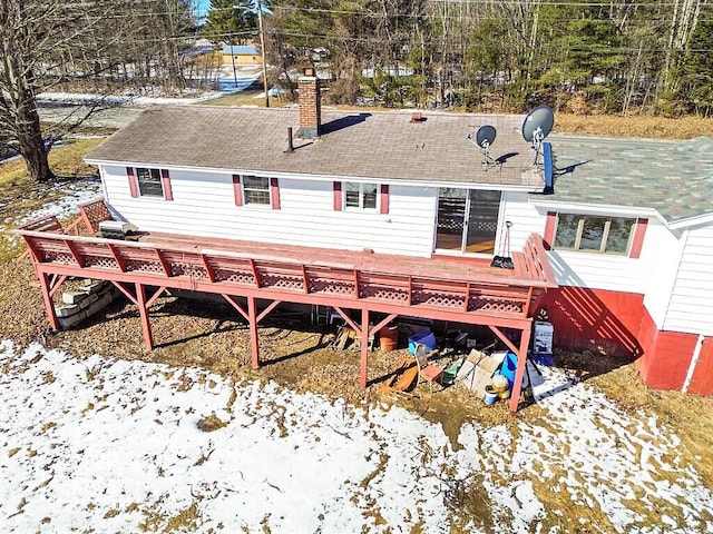 rear view of house with a chimney and a wooden deck