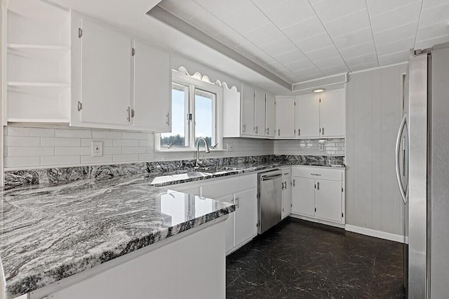 kitchen with white cabinetry, stone counters, appliances with stainless steel finishes, and open shelves
