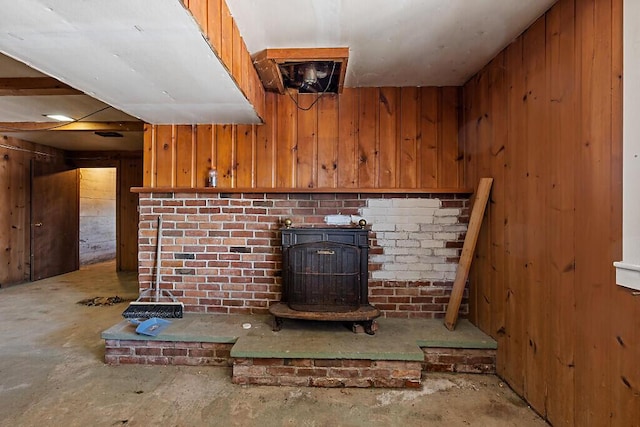 room details featuring wood walls and a wood stove
