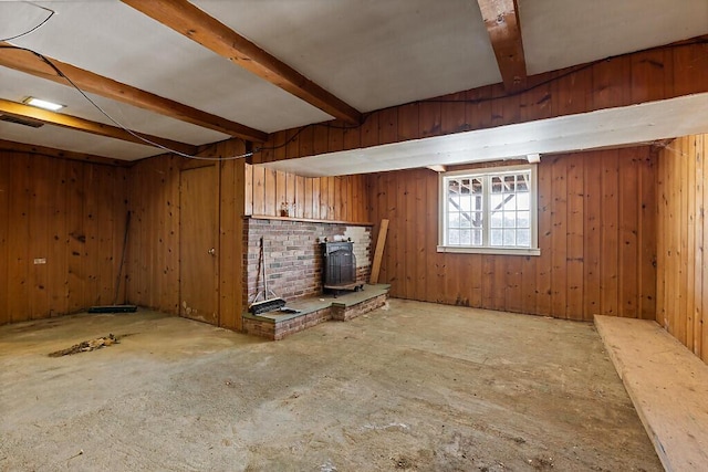 below grade area featuring a wood stove and wooden walls