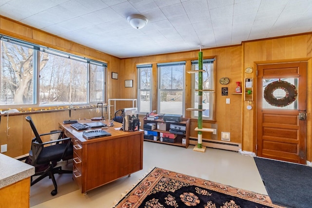 home office with a baseboard radiator and wooden walls