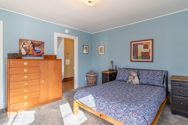 bedroom featuring ornamental molding and carpet