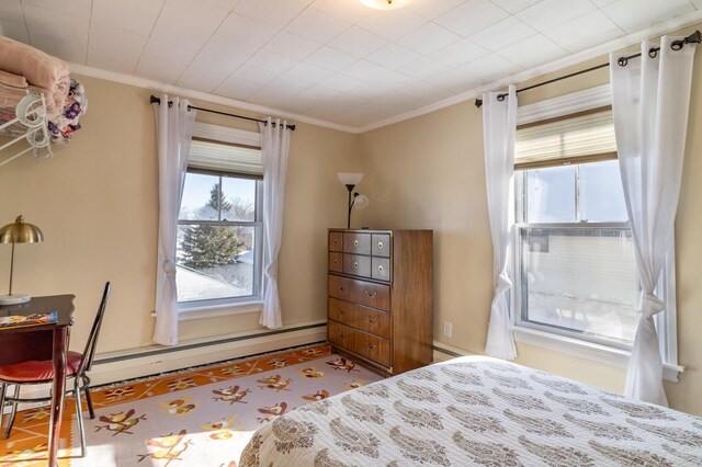 bedroom with ornamental molding and a baseboard radiator