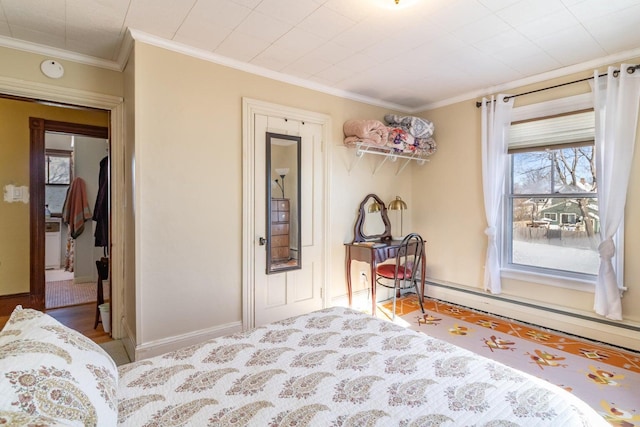 bedroom with crown molding, a baseboard radiator, and baseboards