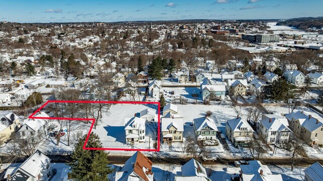 snowy aerial view with a residential view