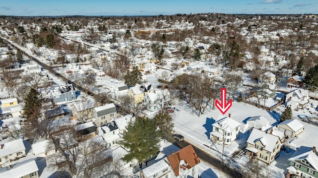 snowy aerial view featuring a residential view
