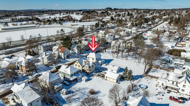snowy aerial view with a residential view