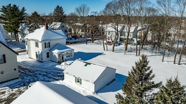 snowy aerial view featuring a residential view