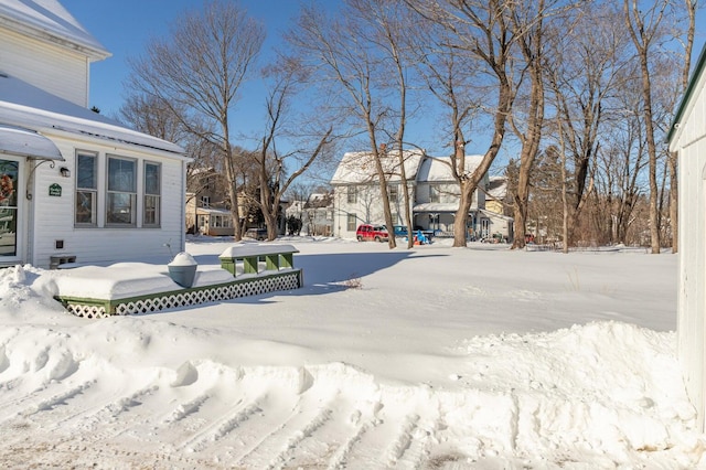 yard layered in snow with a wooden deck