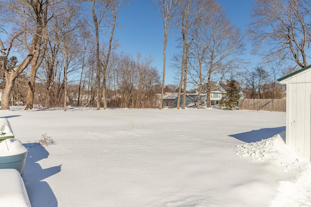 snowy yard with fence