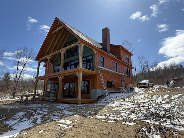46 Harmony Row, Bethel, ME 04217 - snow covered house featuring a chimney and french doors