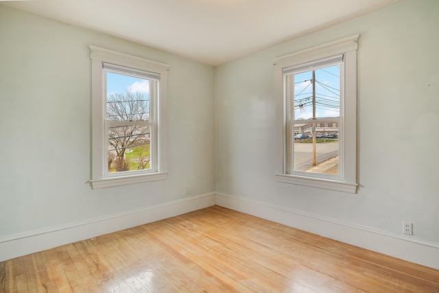 empty room featuring baseboards and wood finished floors