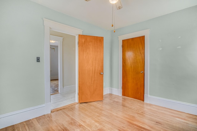 unfurnished bedroom featuring baseboards and wood finished floors