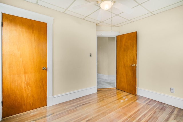 unfurnished room featuring baseboards, a ceiling fan, and wood finished floors
