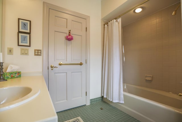 full bath with tile patterned floors, shower / bathtub combination with curtain, and vanity