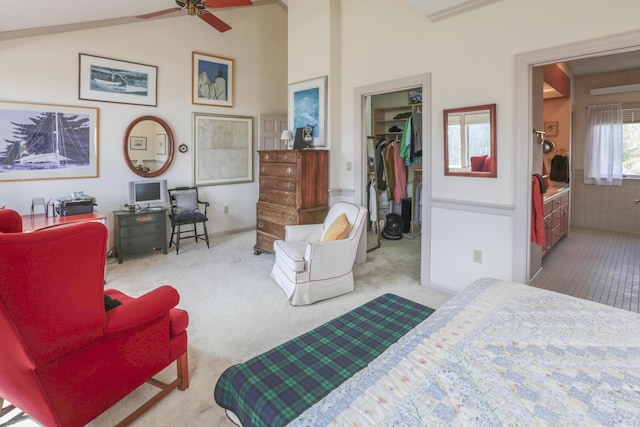 carpeted bedroom featuring a walk in closet, a closet, and lofted ceiling