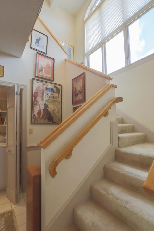 stairway with tile patterned flooring