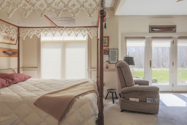 carpeted bedroom with a wainscoted wall, access to outside, and crown molding