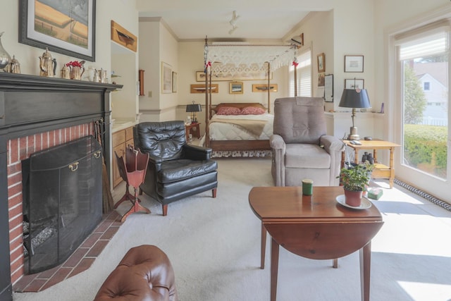 carpeted living area with a brick fireplace
