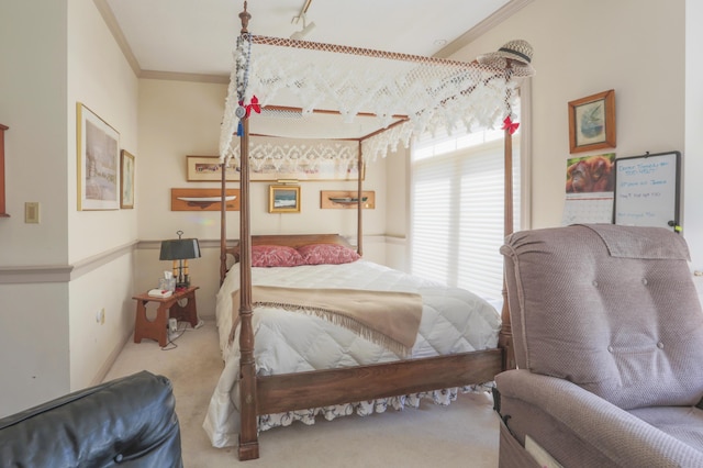 bedroom with ornamental molding and carpet flooring