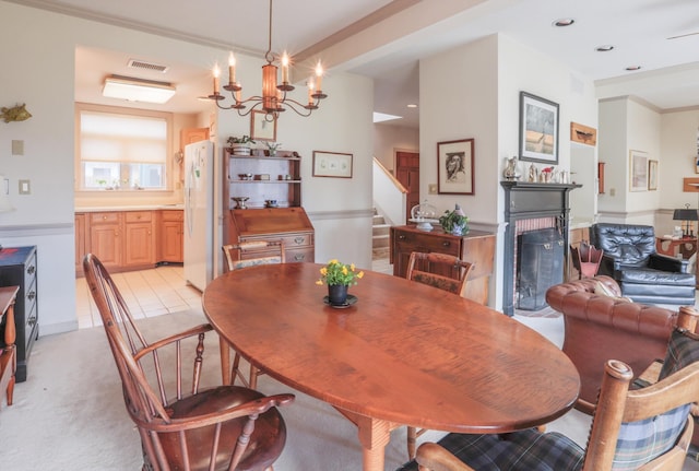 91 Dockside Ln Unit 5, Belfast, ME 04915 - dining room with stairway, a fireplace, a chandelier, light colored carpet, and recessed lighting