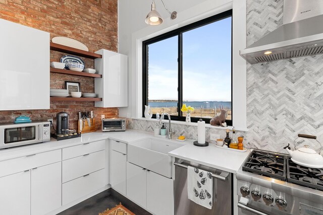 21 Atlantic St, Rockland, ME 04841 - kitchen with tasteful backsplash, open shelves, a sink, wall chimney range hood, and white microwave