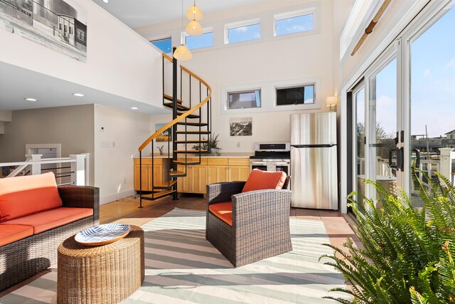 21 Atlantic St, Rockland, ME 04841 - living area with a healthy amount of sunlight, a high ceiling, and stairway