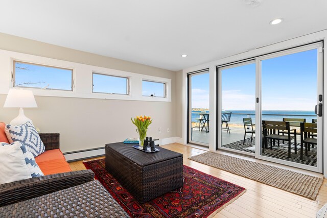 21 Atlantic St, Rockland, ME 04841 - living area featuring a water view, recessed lighting, light wood finished floors, and a baseboard radiator