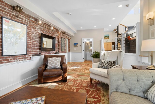 21 Atlantic St, Rockland, ME 04841 - living room featuring brick wall, wainscoting, and recessed lighting