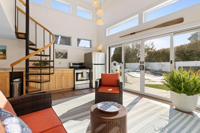21 Atlantic St, Rockland, ME 04841 - living room featuring stairs, a towering ceiling, french doors, and light tile patterned flooring