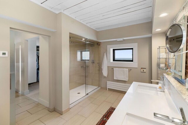 21 Atlantic St, Rockland, ME 04841 - bathroom featuring baseboards, a sink, recessed lighting, double vanity, and a stall shower