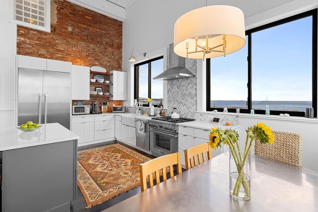 21 Atlantic St, Rockland, ME 04841 - kitchen with a towering ceiling, light countertops, open shelves, high end appliances, and wall chimney exhaust hood