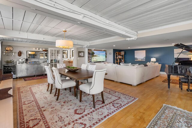 21 Atlantic St, Rockland, ME 04841 - dining space featuring bar, beam ceiling, light wood-style flooring, and beverage cooler