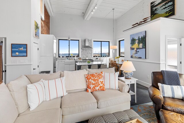 21 Atlantic St, Rockland, ME 04841 - living room with track lighting, wainscoting, a towering ceiling, and beamed ceiling