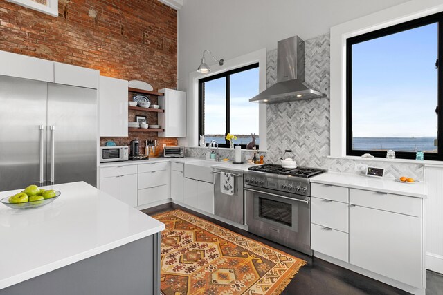 21 Atlantic St, Rockland, ME 04841 - kitchen featuring premium appliances, modern cabinets, wall chimney exhaust hood, and open shelves