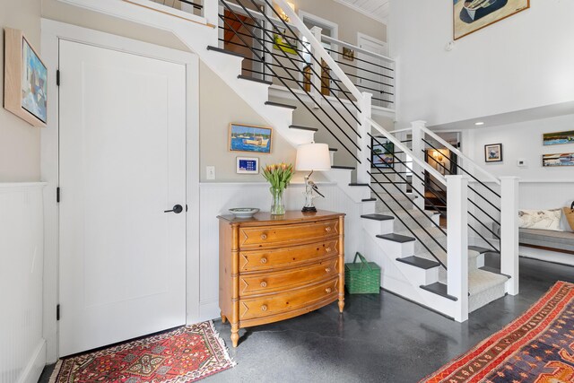 21 Atlantic St, Rockland, ME 04841 - staircase featuring concrete floors and wainscoting