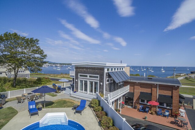 21 Atlantic St, Rockland, ME 04841 - back of property with a patio, a fenced backyard, and a water view