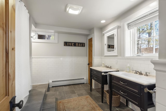27 Miller Ln, Alfred, ME 04002 - full bath with tile walls, tile patterned floors, two vanities, wainscoting, and a baseboard radiator
