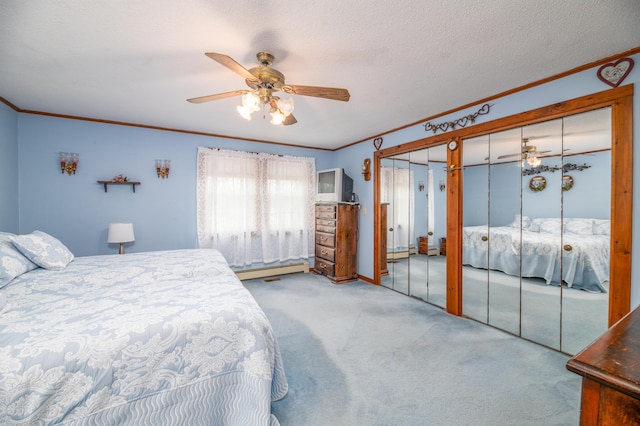 481 Washington Rd, Jefferson, ME 04348 - carpeted bedroom featuring crown molding, multiple closets, ceiling fan, baseboard heating, and a textured ceiling