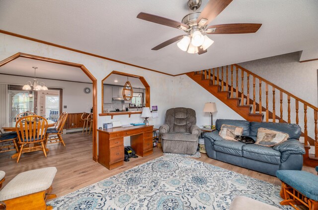 481 Washington Rd, Jefferson, ME 04348 - living area featuring crown molding, baseboard heating, ceiling fan with notable chandelier, stairs, and light wood-type flooring