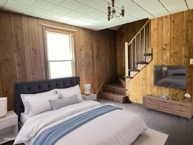 bedroom with wood walls and carpet flooring