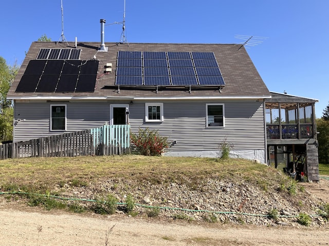 44 Webb Pond Rd, Eastbrook, ME 04634 - rear view of house featuring solar panels and a sunroom
